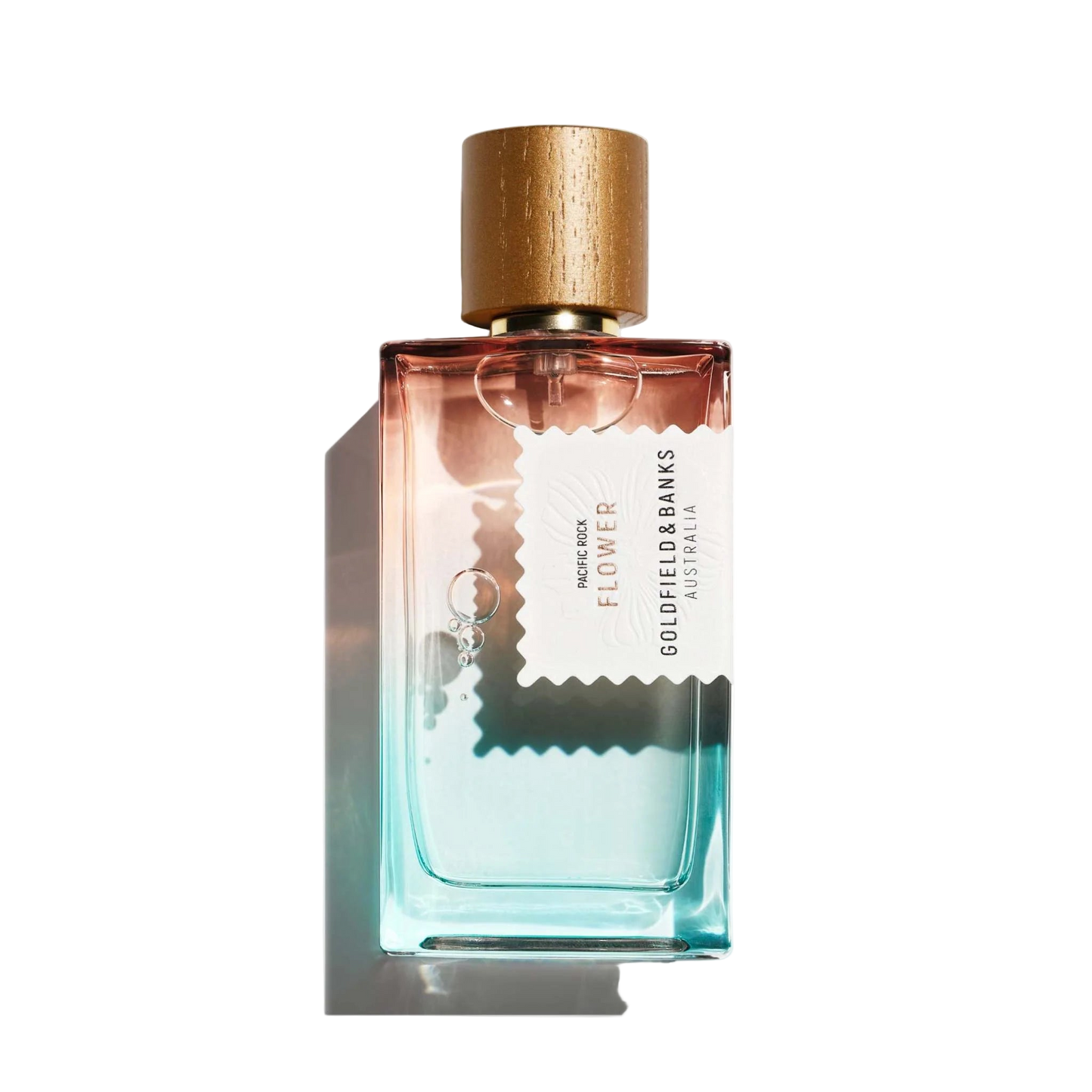 Perfume bottle with gold cap and gradient design on a white background