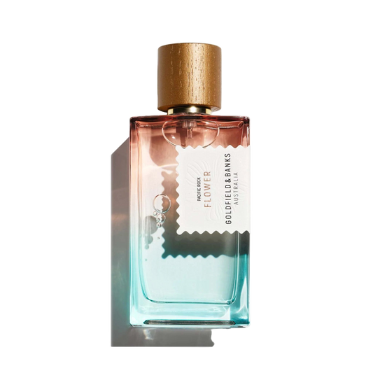 Perfume bottle with gold cap and gradient design on a white background